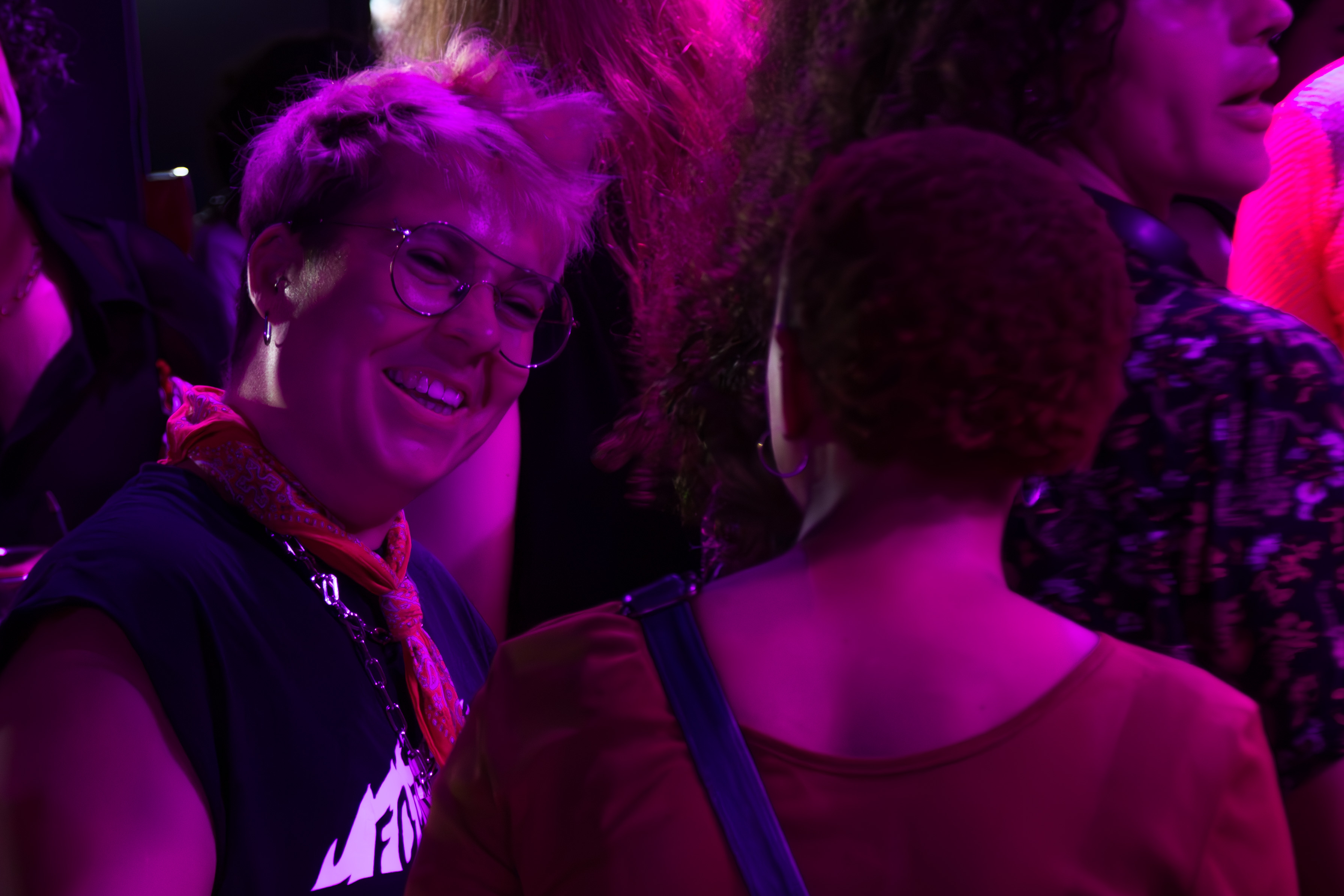 two people at the party talking and smiling